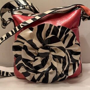 Hot pink and black crossbody bag with large flower petal detail